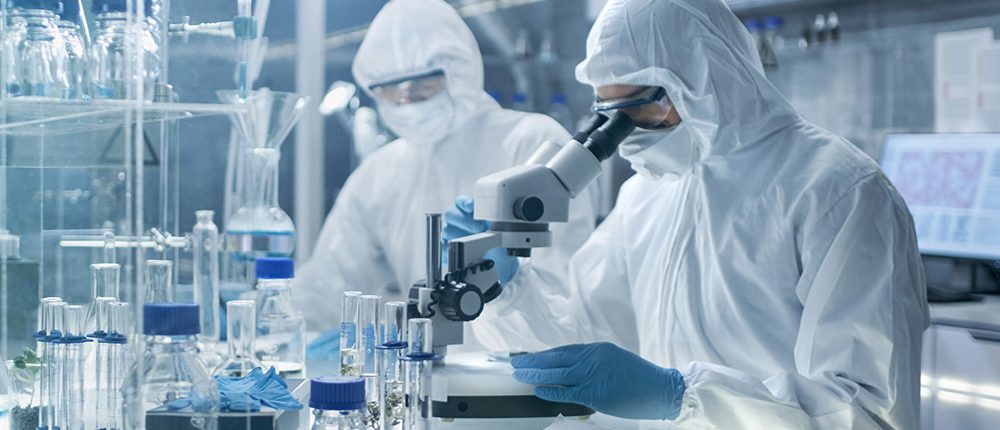 Chemist Adjusts Samples in a Petri Dish with Pincers and then Examines Them Under Microscope